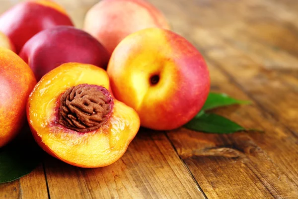 depositphotos_84309860-stock-photo-fresh-peaches-on-wooden-background